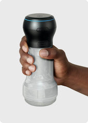 Hand gripping assembled Powerblow Pocket Stroker Crystal from below, Kiiroo logo and blue LED ring visible