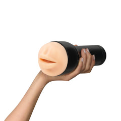 Hand gripping the black casing of the Feel Stroker mouth stroker, front opening visible