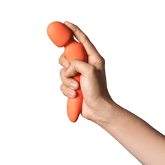 Hand gripping Dame Min Mini Wand vibrator showing compact, palm-friendly size and flexible neck