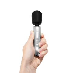 Hand gripping Doxy Go wand vertically, demonstrating its compact ergonomic handle size