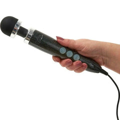 Hand gripping the Doxy wand massager showing ergonomic handle size and button placement