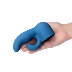 Hand gripping Dual Petite blue silicone attachment, dual-arm shape visible from side angle