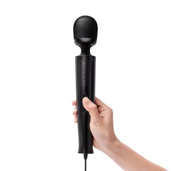 Hand gripping the handle of the Le Wand Die Cast wand massager showing ergonomic scale