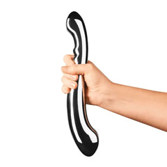 Hand gripping Le Wand Contour stainless steel wand upright, showing full scale