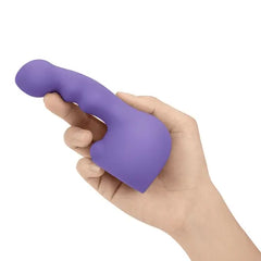 Close-up of hand gripping Ripple Petite attachment, showing ribbed curved shaft detail