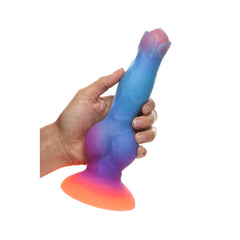 Hand gripping the Space Cock alien dildo to demonstrate grip size and flexible silicone texture