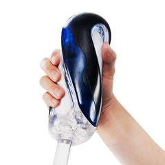 Hand gripping the Tenga FLIP 360 upright, showing blue-black exterior and clear inner sleeve