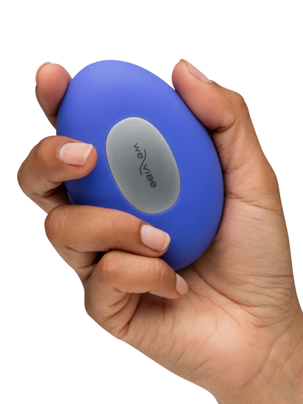 Hand gripping We-Vibe Temp lavender blue vibrator, showing metallic We-Vibe logo panel