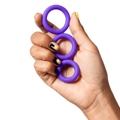 Hand holding all three ROMP Remix Trio silicone cock rings stacked between fingers