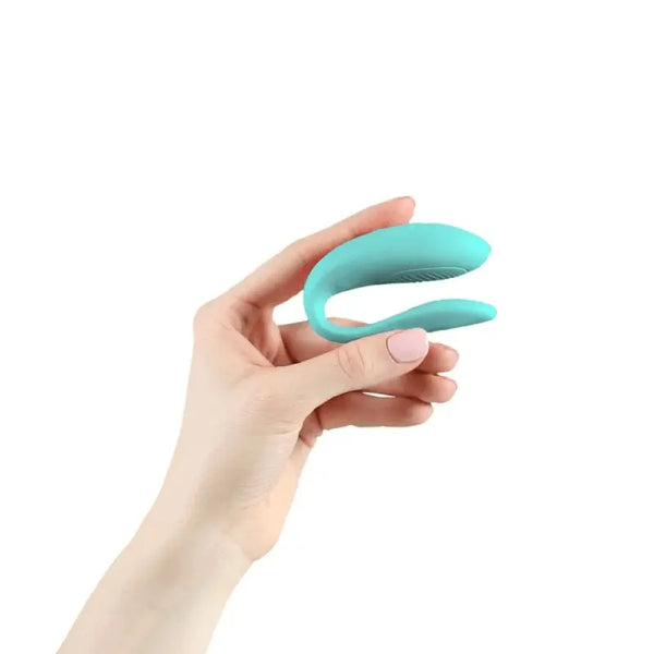 Hand holding the aqua We-Vibe Sync Lite to show its compact, palm-sized scale