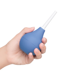 Hand holding the b-Vibe enema douche to demonstrate its compact palm-sized capacity