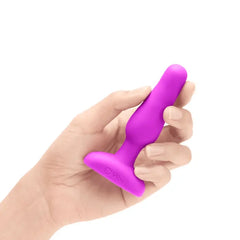 Hand holding b-Vibe Novice Plug showing compact beginner-friendly silicone size