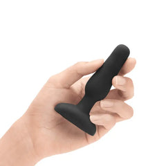 Hand holding b-Vibe Novice Plug to demonstrate its compact, beginner-friendly size