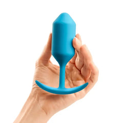 Hand holding b-Vibe Snug Plug 3 blue silicone weighted plug to show size and scale