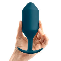 Hand holding b-Vibe Snug Plug 6 in marine teal to illustrate the plug's large size and scale