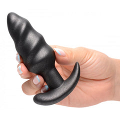 Hand holding Bang! Platinum Series black swirl butt plug showing twisted ridged shape