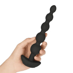 Hand holding black b-Vibe Cinco silicone beaded anal toy to show scale and flexible feel