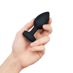 Hand holding black silicone b-Vibe jewel plug to show compact M/L size and grip