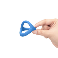 Hand holding blue silicone tri-sling to show compact, lightweight size and flexibility