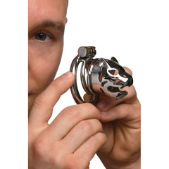 Hand holding the Caged Cougar stainless steel chastity cage to show compact size and detail