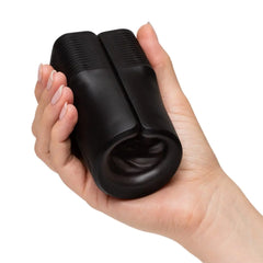 Hand holding the compact black Arcwave Zing stroker, demonstrating palm-sized ergonomic form factor