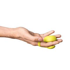 Hand holding Dame Fin Citrus 2.0 finger vibrator, loop resting on middle finger, palm-up grip