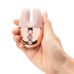 Hand holding Double Vibe to show compact palm-sized scale with three-button rose gold panel