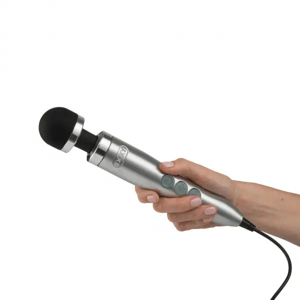 Hand holding the Doxy Die Cast 3 wand massager, showing its ergonomic grip and compact size