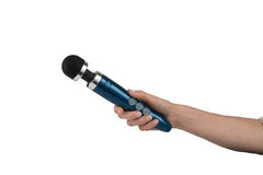Hand holding the Doxy Die Cast 3R blue wand vibrator showing three control buttons