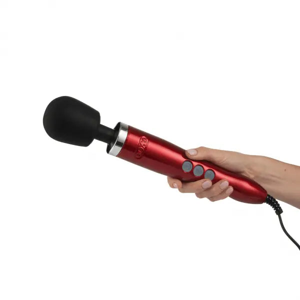 Hand holding the Doxy Die Cast red wand massager showing ergonomic grip size and corded design