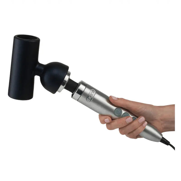 Hand holding Doxy Die Cast wand with masturbator sleeve attached, shown at a horizontal angle