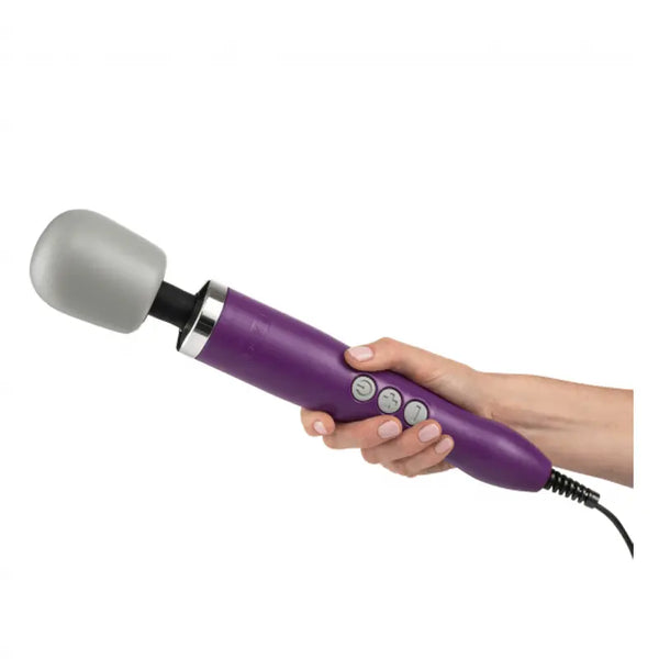 Hand holding the Doxy wand massager showing ergonomic purple handle and corded design