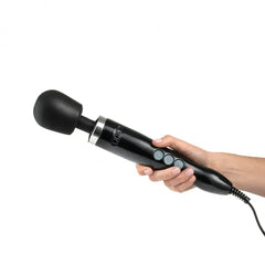Hand holding the Doxy wand massager by its textured black handle, showing natural grip size