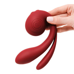Hand holding Gizi Pro vibrator displaying three flexible arms and spiral-textured handle