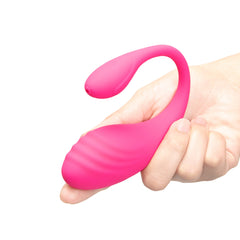 Hand holding large ribbed vibrating egg to illustrate its wearable insertable size and curved tail