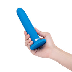 Hand holding largest b-Vibe blue silicone dilator to show size scale and suction base
