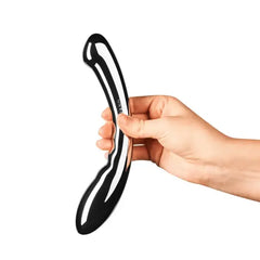 Hand holding Le Wand Arch stainless steel dildo upright to show dual-end curved design