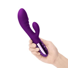 Hand holding Le Wand Blend rabbit vibrator showing scale and three-button control