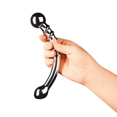 Hand holding Le Wand Bow dildo from opposite angle with smaller curved end facing upward