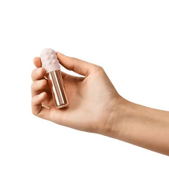 Hand holding Le Wand Bullet vibrator showing compact palm-sized scale