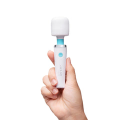 Hand holding Le Wand Classique Mini wand massager showing compact travel-friendly size and scale