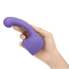 Hand holding Le Wand Curve Petite attachment upright, curved tip and hollow base visible