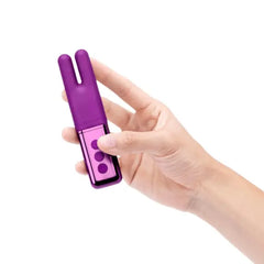Hand holding Le Wand Deux Dark Cherry vibrator to show compact, palm-sized scale