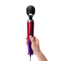 Hand holding Le Wand Die Cast Massager upright, showing full ombre handle and soft head