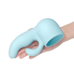 Hand holding Le Wand Dual blue silicone attachment to show interior fit and scale