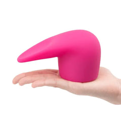 Hand holding Le Wand Flick pink silicone attachment to show size and soft flexibility
