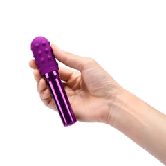 Hand holding Le Wand Grand Bullet to show compact size of textured silicone-sleeved vibrator
