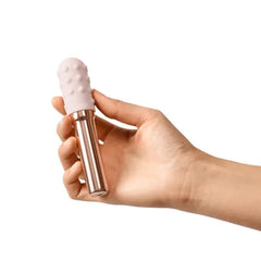Hand holding Le Wand Grand Bullet vibrator showing compact size and easy single-hand grip