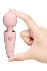Hand holding Le Wand Microwand upright between fingers highlighting the rounded silicone head