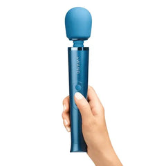 Hand holding Le Wand Petite Massager upright showing ergonomic grip and rounded silicone head